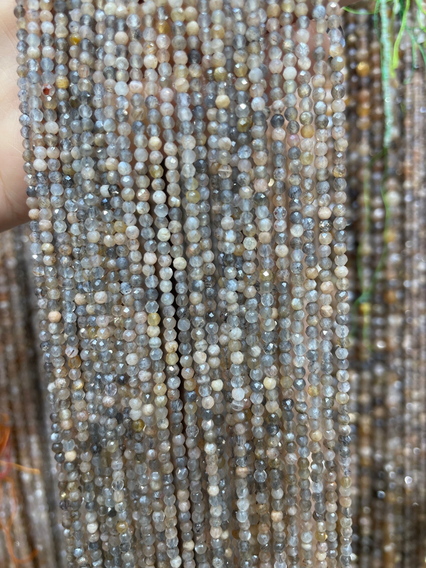 faceted black skeleton sunstone strand 2mm